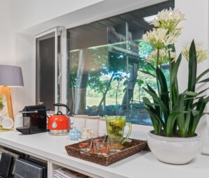 Relaxing studio setting at The Design Barn with coffee machine, window, and luxury fabrics & wallcoverings